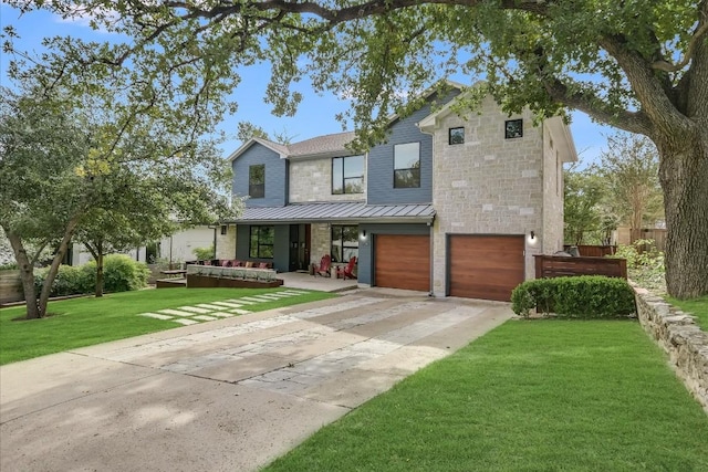 view of front of property featuring a garage and a front yard