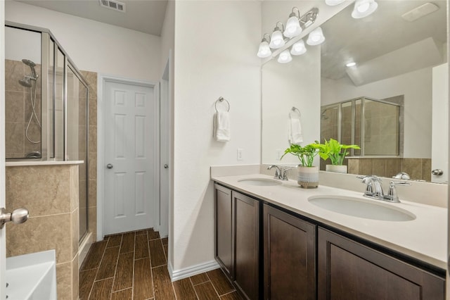 21005 Isle Of Glass St, Pflugerville, TX 78660 - full bath with a shower stall, double vanity, wood tiled floors, and a tub to relax in