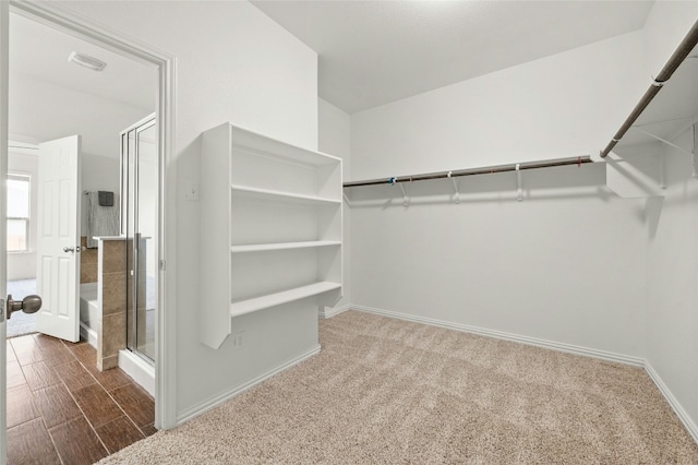 walk in closet with dark wood-type flooring