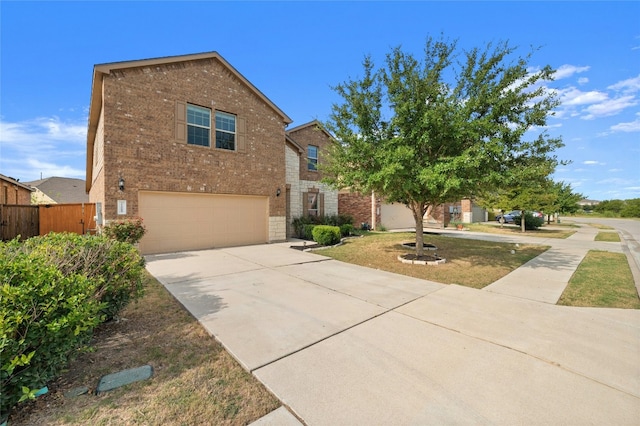 traditional home with brick siding, concrete driveway, a garage, and fence