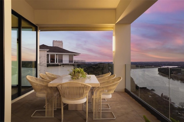 balcony at dusk with a water view