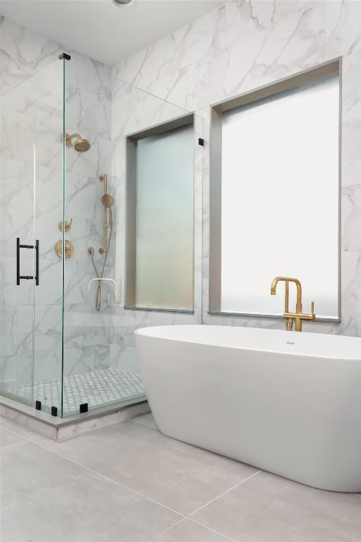 bathroom featuring independent shower and bath and tile walls