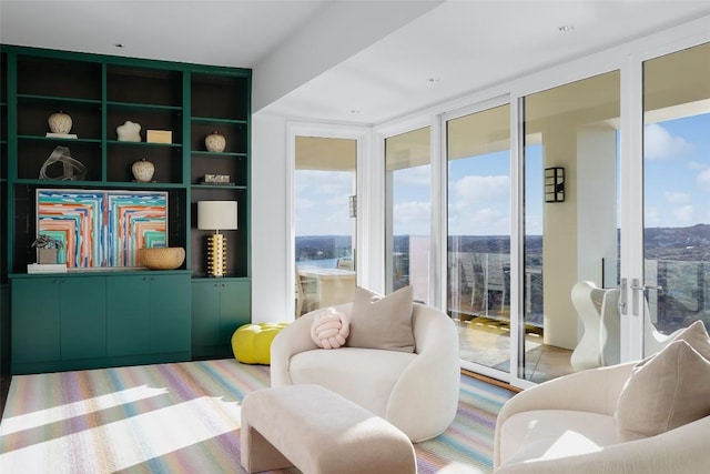 living area featuring hardwood / wood-style floors and a wall of windows