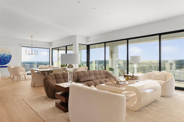 living room with a chandelier and light hardwood / wood-style flooring