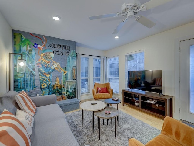 living room with hardwood / wood-style flooring and ceiling fan