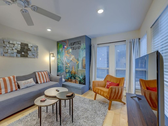 living room featuring hardwood / wood-style flooring and ceiling fan