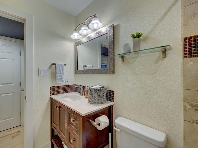 bathroom featuring hardwood / wood-style floors, vanity, and toilet