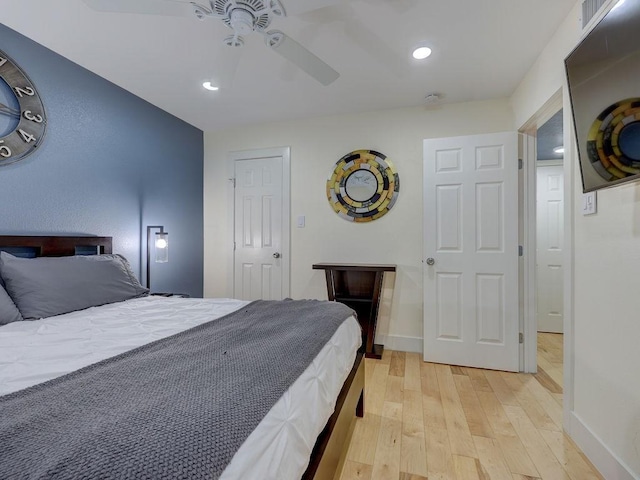 bedroom with ceiling fan and light hardwood / wood-style floors