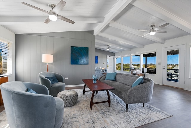 living room with hardwood / wood-style flooring, ceiling fan, and lofted ceiling with beams