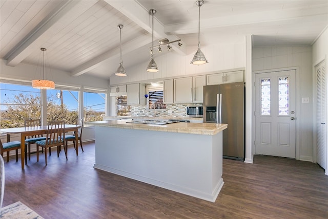 kitchen featuring light stone counters, stainless steel appliances, dark hardwood / wood-style flooring, and pendant lighting