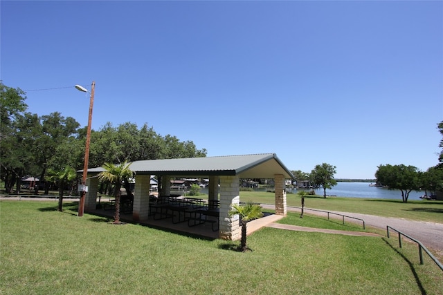 view of property's community featuring a water view, a gazebo, and a lawn