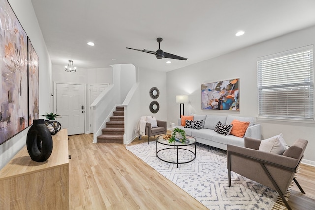 living room featuring ceiling fan and light hardwood / wood-style floors