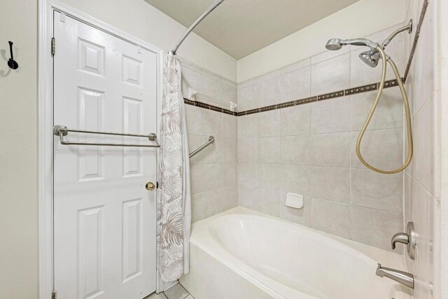 bathroom featuring shower / bathtub combination with curtain