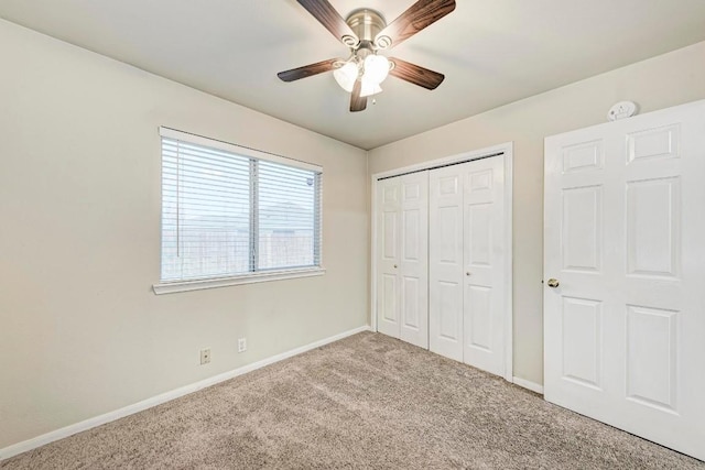 unfurnished bedroom with carpet, ceiling fan, and a closet