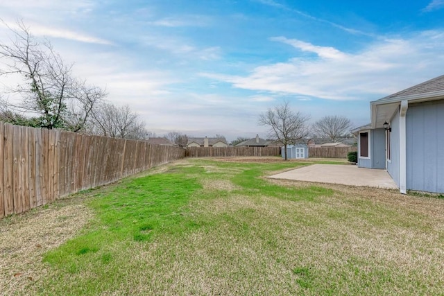 view of yard featuring a shed and a patio