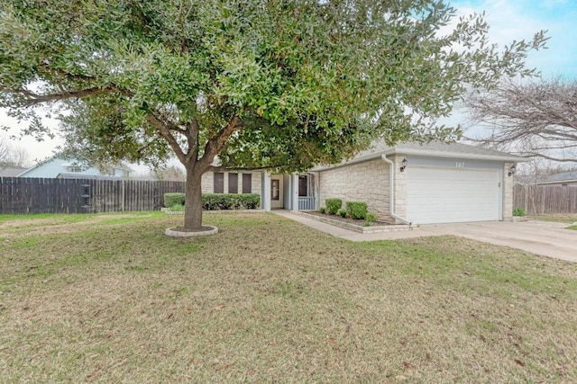 view of front of property with a garage and a front lawn