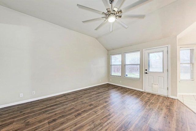 interior space with dark wood-type flooring, vaulted ceiling, and ceiling fan