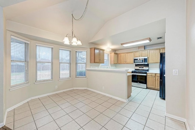 kitchen featuring pendant lighting, light tile patterned floors, kitchen peninsula, stainless steel appliances, and an inviting chandelier