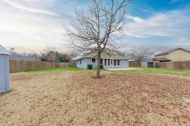 view of yard featuring a patio area and a storage shed