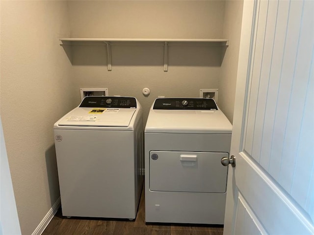 laundry area featuring dark wood-type flooring and washing machine and dryer