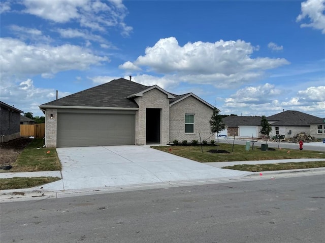 view of front of property with a garage and a front lawn