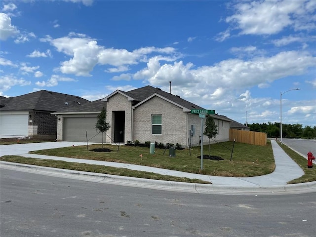 ranch-style home featuring a garage and a front lawn