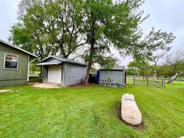 view of yard with a garage and an outdoor structure