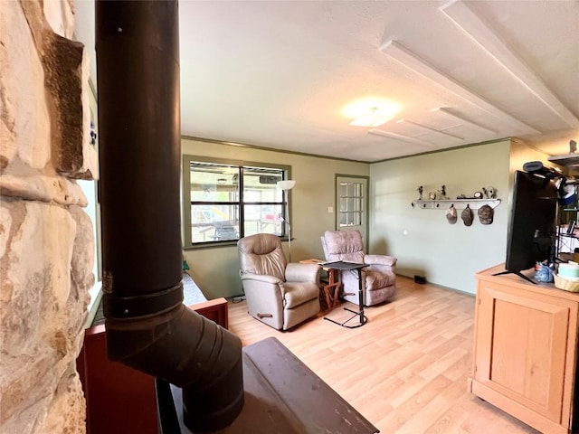 living room featuring light hardwood / wood-style flooring and ornate columns