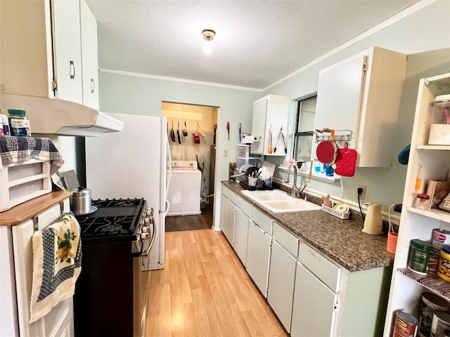 kitchen with stainless steel range with gas cooktop, washer / clothes dryer, white cabinetry, sink, and light hardwood / wood-style floors