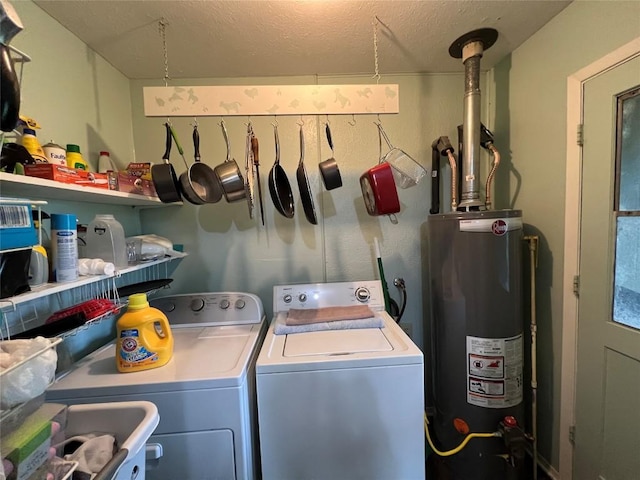 laundry area with gas water heater, independent washer and dryer, and a textured ceiling