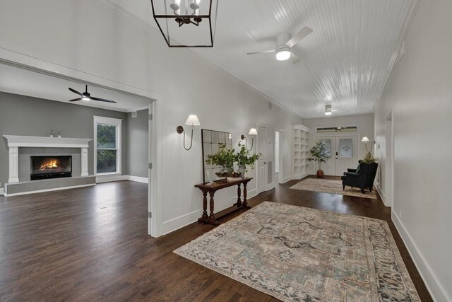 interior space with crown molding, ceiling fan, and dark hardwood / wood-style flooring