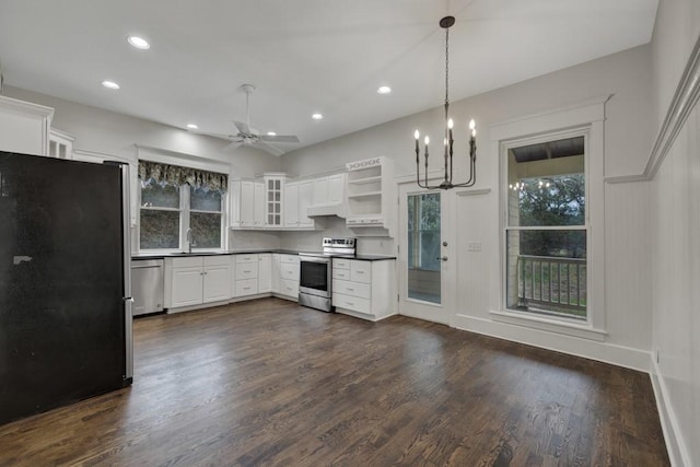 kitchen with sink, decorative light fixtures, appliances with stainless steel finishes, dark hardwood / wood-style floors, and white cabinets