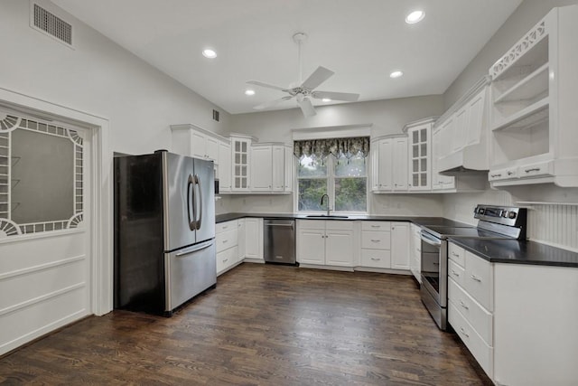 kitchen with sink, ceiling fan, appliances with stainless steel finishes, dark hardwood / wood-style floors, and white cabinets