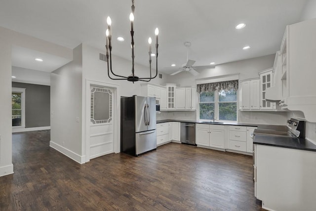 kitchen featuring white cabinetry, appliances with stainless steel finishes, dark wood-type flooring, and sink