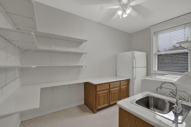 interior space with washer / clothes dryer, sink, and ceiling fan