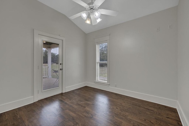 empty room featuring vaulted ceiling, dark wood-type flooring, and ceiling fan