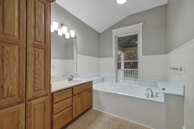 bathroom with vanity, tile patterned flooring, vaulted ceiling, and a bathtub