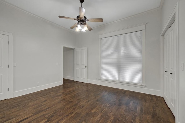 unfurnished bedroom with dark hardwood / wood-style flooring, ornamental molding, and ceiling fan