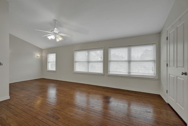 spare room with vaulted ceiling, dark wood-type flooring, and ceiling fan