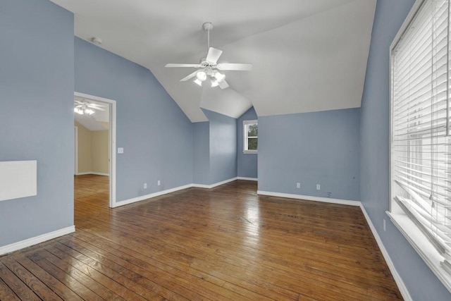 additional living space featuring dark hardwood / wood-style flooring, lofted ceiling, and ceiling fan