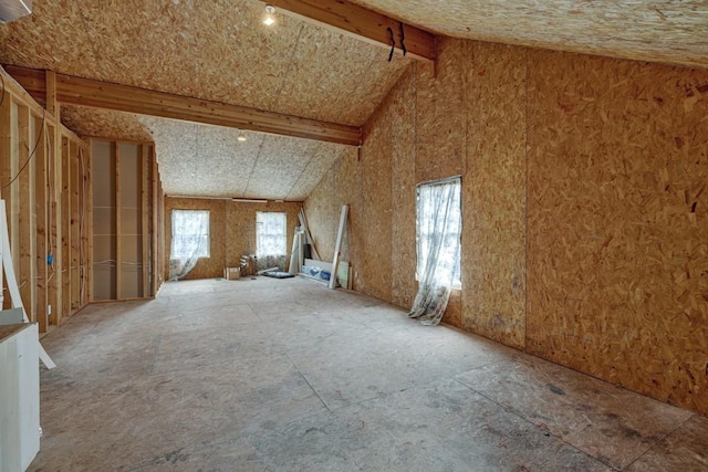 misc room featuring beam ceiling and high vaulted ceiling