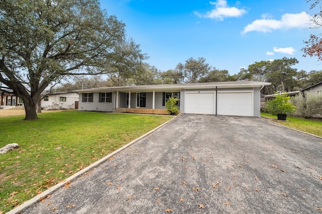 single story home with a garage and a front lawn