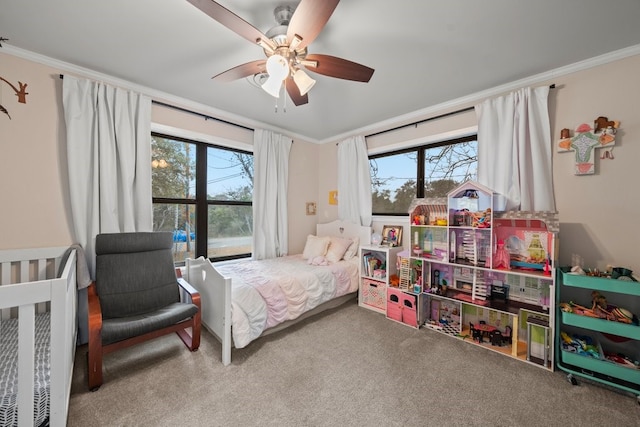 bedroom featuring multiple windows, ornamental molding, carpet, and ceiling fan