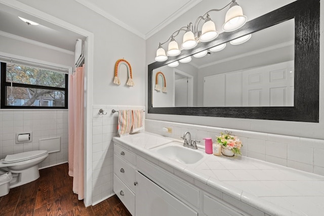 bathroom featuring toilet, crown molding, tile walls, vanity, and hardwood / wood-style flooring