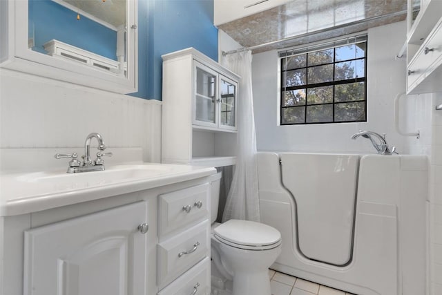 full bathroom featuring vanity, tile patterned floors, toilet, and separate shower and tub