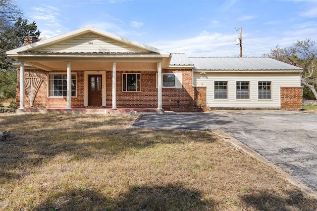 view of front of home with a front yard and a porch