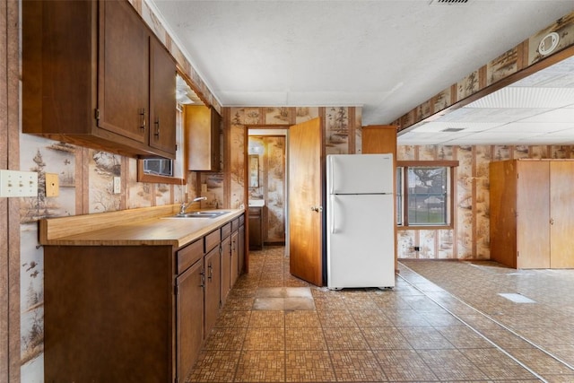 kitchen with sink and white fridge