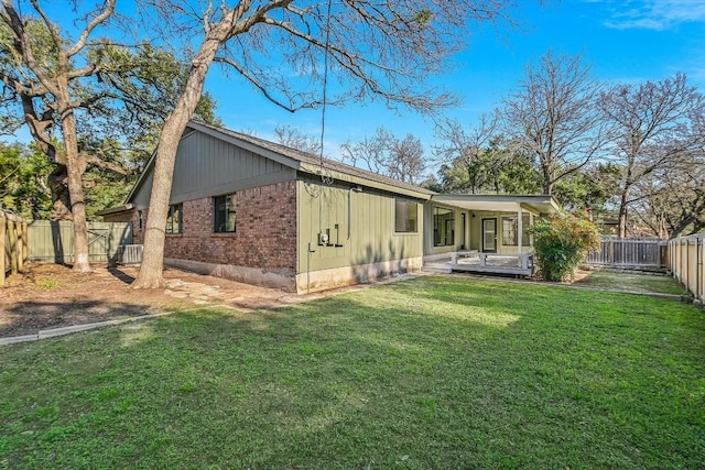 back of property featuring a lawn