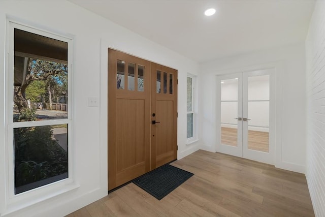 foyer featuring light hardwood / wood-style floors and french doors