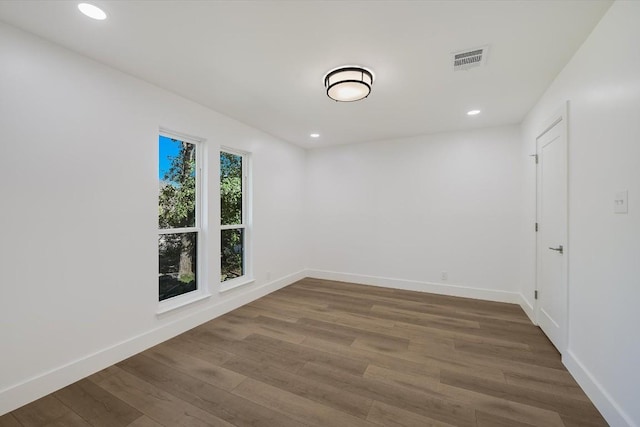 unfurnished room with hardwood / wood-style floors